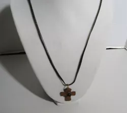 This is a hand crafted copper cross with a small amber color stone in center. It is on a leather tie cord. They will...