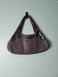 Add a touch of elegance to your look with this beautiful woven leather shoulder bag from Hobo. The rich brown exterior...