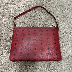 This MCM clutch bag in striking red is a must-have addition to any fashion-forward womans collection. The bag features...
