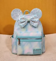 By Loungefly & Disney. Interior is Blue Minnie Mouse Print. Faux Leather Exterior with Sequin Accents. Height 10