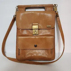 A rare find! This lightweight handbag is in soft tan leather. Last two photos of bag show the only signs of wear. Brass...