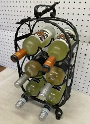 Wrought Iron 6 Bottle Wine Rack Detailed w/ Grape Leaves. It measure approximately 20” high, 10” wide and 6”...
