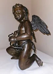 Art Nouveau Style Cupid Cherub made of some sort of heavy metal I believe to be brass, but it might be bronze, Im just...
