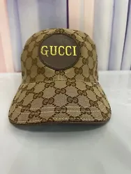 Gucci brown adjustable baseball cap with gold lettering print with dust bag and no label was not used