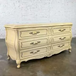 “Quelle BELLE commode!”. That’s French for “What a BEAUTIFUL dresser!”. The darker areas of the wood give off...