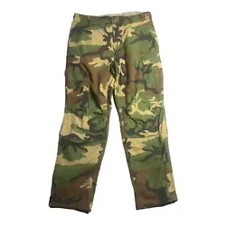 Step up your style game with these vintage U.S. Army military combat pants in a classic woodland camouflage pattern....