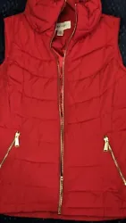 Elevate your winter wardrobe with this Calvin Klein Classic Puffer Vest in an elegant red color. This vest features a...
