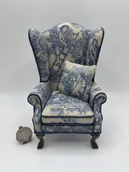 Upholstery in a blue & grayish white, removable throw pillow, nice wood legs. Pillow has double sided sticky tape to...