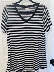 Polyester spandex. Black and white stripes. V-neck, short sleeves, slight hi low hem. Preowned in excellent condition.