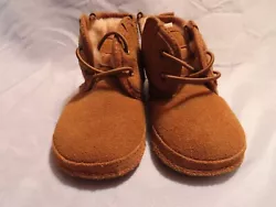 For auction is a pair of Toddler Booties size 4-5 ( ages 9 months to 4 years) by UGG in brown. They are in excellent...