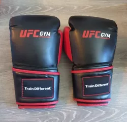Almost totally unused. These gloves are in excellent condition. 16 oz. UFC Gym adult size boxing and training gloves....