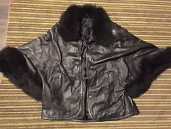 fuzzy genuine leather black winter coat, the buttons look like creatures eyes.. very unique gothic coat
