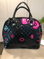 Black quilted patent leather base with hot pink Hello Kitty face with large bow across the entire front of the bag....