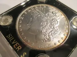 1899 O Morgan Dollar in Choice BU.The red spot-on rev.wing was on the holder.