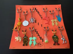 Vtg Toy Novelty Key Chains Vending Display Robots Skeletons Peace Animals Charms. Shipping is to continental 48 states....