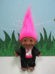 His hair is a vibrant pink color. He has not had a previous owner, or been displayed.