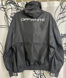 Off White Virgil Abloh black rain jacket with reflective white logo lettering. Zip up front with 2 zipper pockets,...
