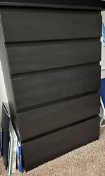 IKEA Black 5 Drawer Dresser. The outside of the dresser measures out to be 16”L x 34.75” H x 27 3/8” W. The...