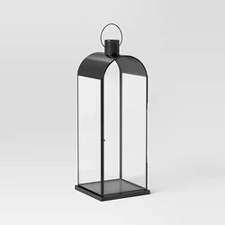 •Tall metal lantern •Black-finish frame •Holds a pillar candle •Comes with a top handle •Suitable for...