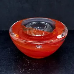 Consists of Red Orange swirls encased in clear glass. Made by Kosta Boda of Sweden, part of their Atoll range, designed...