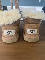 Ugg Toddler Brown Boots Size: Toddler 9. There is a little bit of damage in the front of the boot.