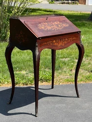 This desk has great proportions and graceful cabriole legs. Opening the slant front writing surface reveals three small...