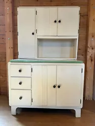 Antique Hoosier Hutch (SOLD) with a tag on the back F105/3  Date 3-9-31. Has flour sifter. Bottom draw has tin base...