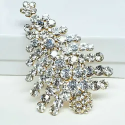 This festive brooch has gorgeous clear crystal rhinestones. There is a simple roll over clasp. The brooch is Unsigned....