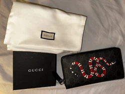 Gucci black supreme GG king snake print long wallet. This unisex wallet features the signature GG gucci print with a...