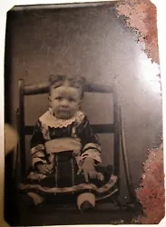 Child Tintype on Chair Beautiful Dress. 1/6 Size Plate 1870’s. probably from the 1870’s. She is wearing a colorful....
