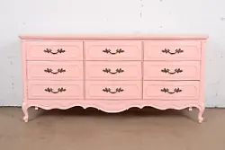 By Thomasville. A gorgeous French Provincial Louis XV style nine-drawer triple dresser or credenza. Pink lacquered...