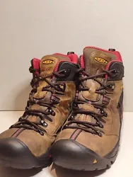 A pair of used mens work boots for someone to wear and enjoy..