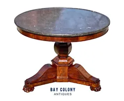 The table has a large circular Onyx top with a raised edge commonly referred to as a dish top. The table has crotch...