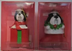 Both black & white dogs, one in red Santa boot, one in red present. New in the display boxes, never removed from the...