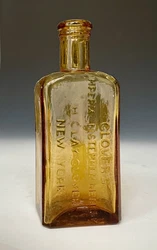 Rectangular form with eased shoulders. Fairly crude; blown in an attractive shade ofyellow amber/apricot glass with...