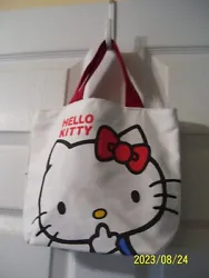 HELLO KITTY creamy white canvas tote bag with red handles. NEVER used. Hello Kitty is on both sides and there is a...