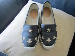 Beautiful shoes. Black with gold bees and stars.