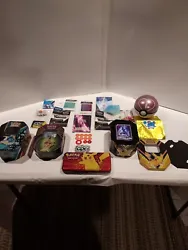 Tins included game starters and dice also I included 2 pokemon custom cards for your enjoyment