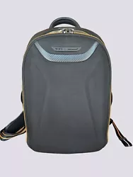 TUMI Tracer®. Hook with leather strap for key ring. Back open pocket with magnetic snap. Card pocket. Padded tablet...