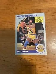 This NBA trading card features the legendary Magic Johnson, who played for the Los Angeles Lakers during the 1990-91...