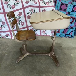 The seat does swivel. I have not tried to raise or lower the desk top or seat. Poor used condition. Wood is stained,...