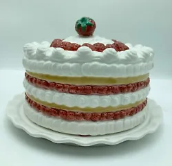 The plate is white and is decorated with handpainted strawberries.