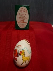 This unusual ornament comes in its original packaging. It is a hand painted egg shell tree ornament distributed by...