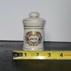 Vintage porcelain apothecary GAUZE jar white with gold trim and bright colored design.