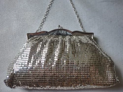 The clasp has a unique carved abalone. This purse looks new besides the discoloration on the silk lining which is...