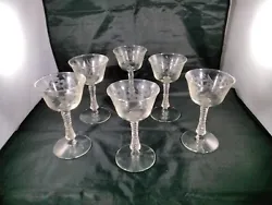 THIS IS A SET OF 6  C,EAR CRYSTAL LIQUOR STEMMED GLASSES WITH ETCHED FLORAL PATTERN  IN GREAT CONDITION NO BREAKS OR...