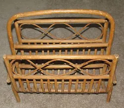 The magazine rack was made in The Philippines with natural bent wood ratan and lace.