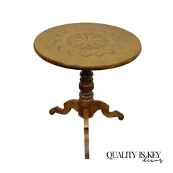 The table features a very nice parquet inlay along the pedestal base as well as the top, shapely tripod legs, and a...