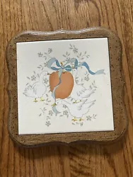 International Marmalade tile trivet with a wood frame. It is in excellent condition.