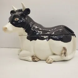 Black And White Realistic Cow Cookie Jar With Cow Cow Laying Down. The handsome cookie jar is in nice pre-owned...